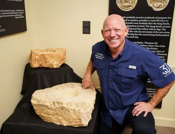 Dr. Scott with upper socket stone from the gate of the city in the Joshua Judges Jesus Exhibit in Texas