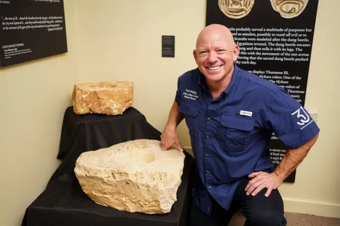 Dr. Scott with upper socket stone from the gate of the city in the Joshua Judges Jesus Exhibit in Texas