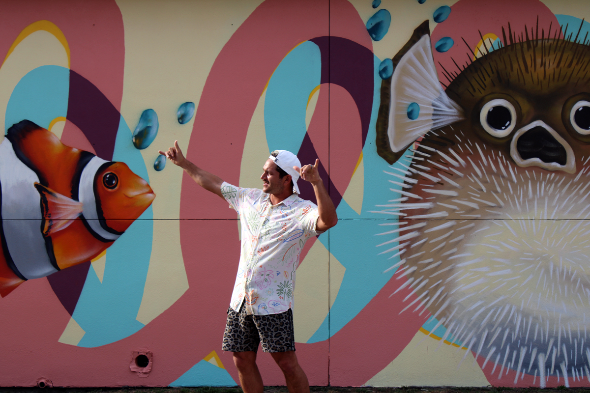 Galveston Artist Gabriel Prusmack in front of one of his murals in Galveston