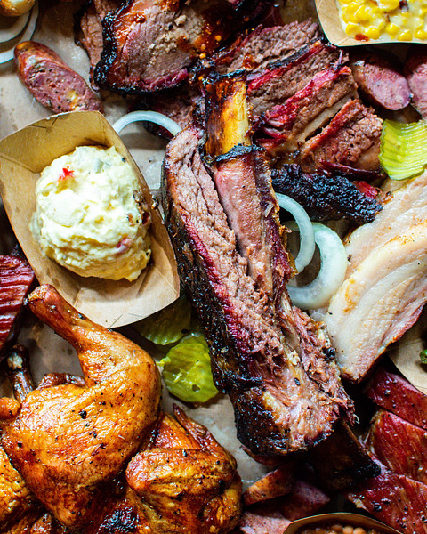 A mouthwatering spread of Texas barbecue goodness—brisket, ribs, smoked chicken, and all the classic sides to satisfy your cravings