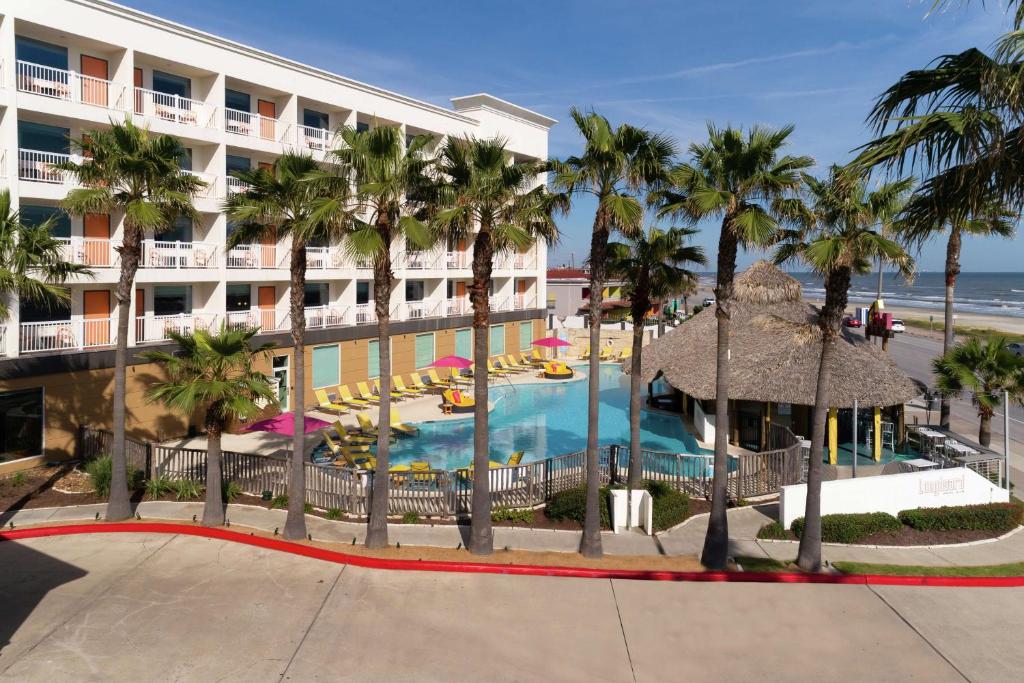Palm trees, poolside vibes, and ocean breezes — your seaside escape starts here. | Source: hilton.com