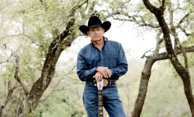 Channeling timeless country charm with a guitar in hand and the open landscape as the backdrop. | Source: texashillcountry.com