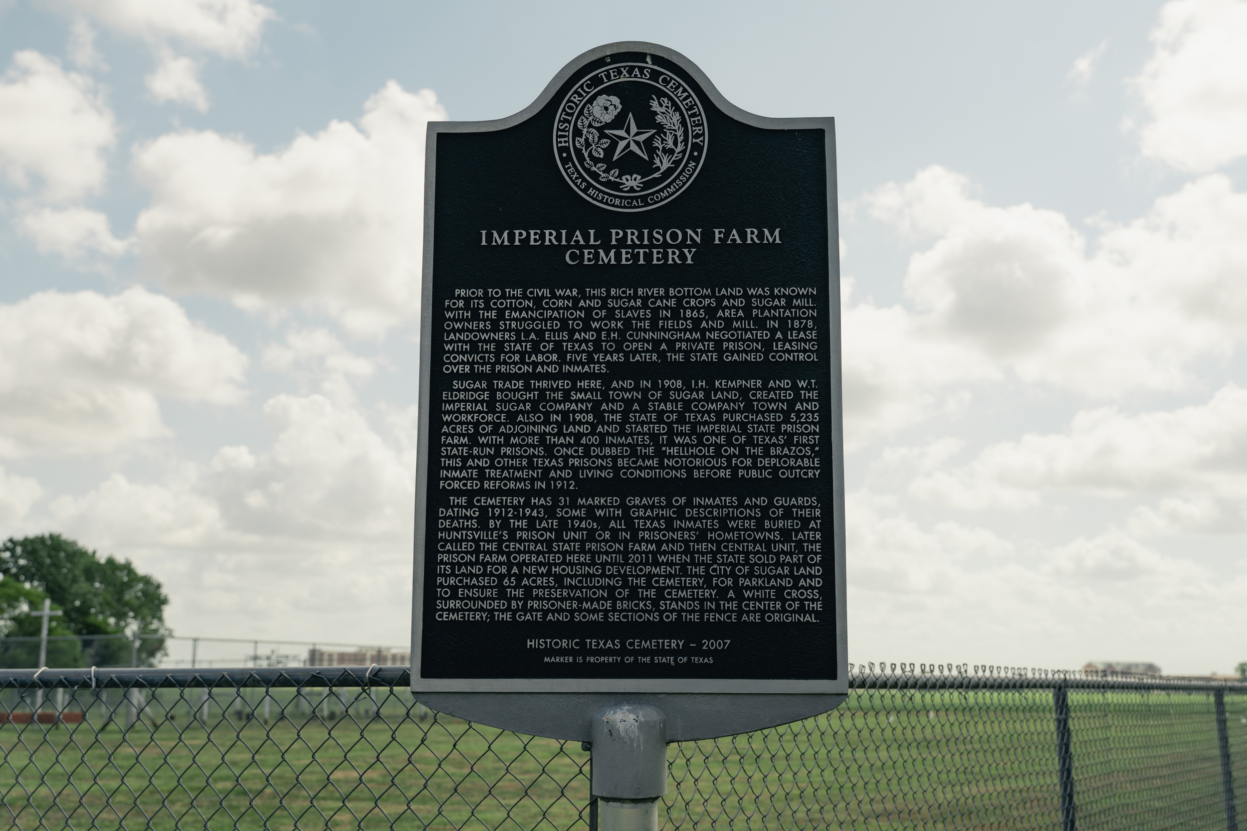 Historical marker at Imperial Prison Farm Cemetery in Sugar Land, Texas, commemorating convict-leasing history.