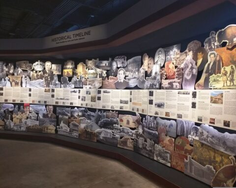 Colorful timeline display of historical photos, articles, and illustrations at Sugar Land Heritage Museum.