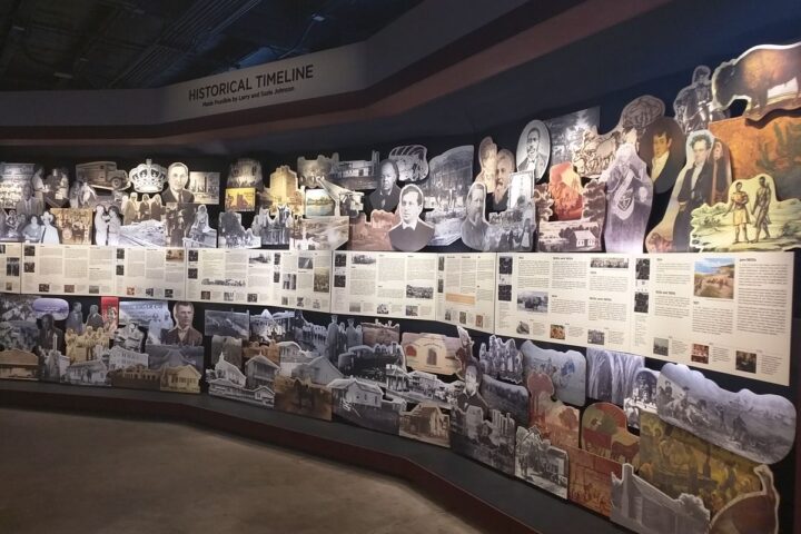 Colorful timeline display of historical photos, articles, and illustrations at Sugar Land Heritage Museum.