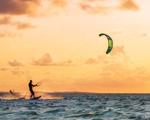 Person kite surfing at sunset on the ocean off South Padre Island.