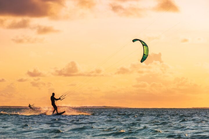 Person kite surfing at sunset on the ocean off South Padre Island.