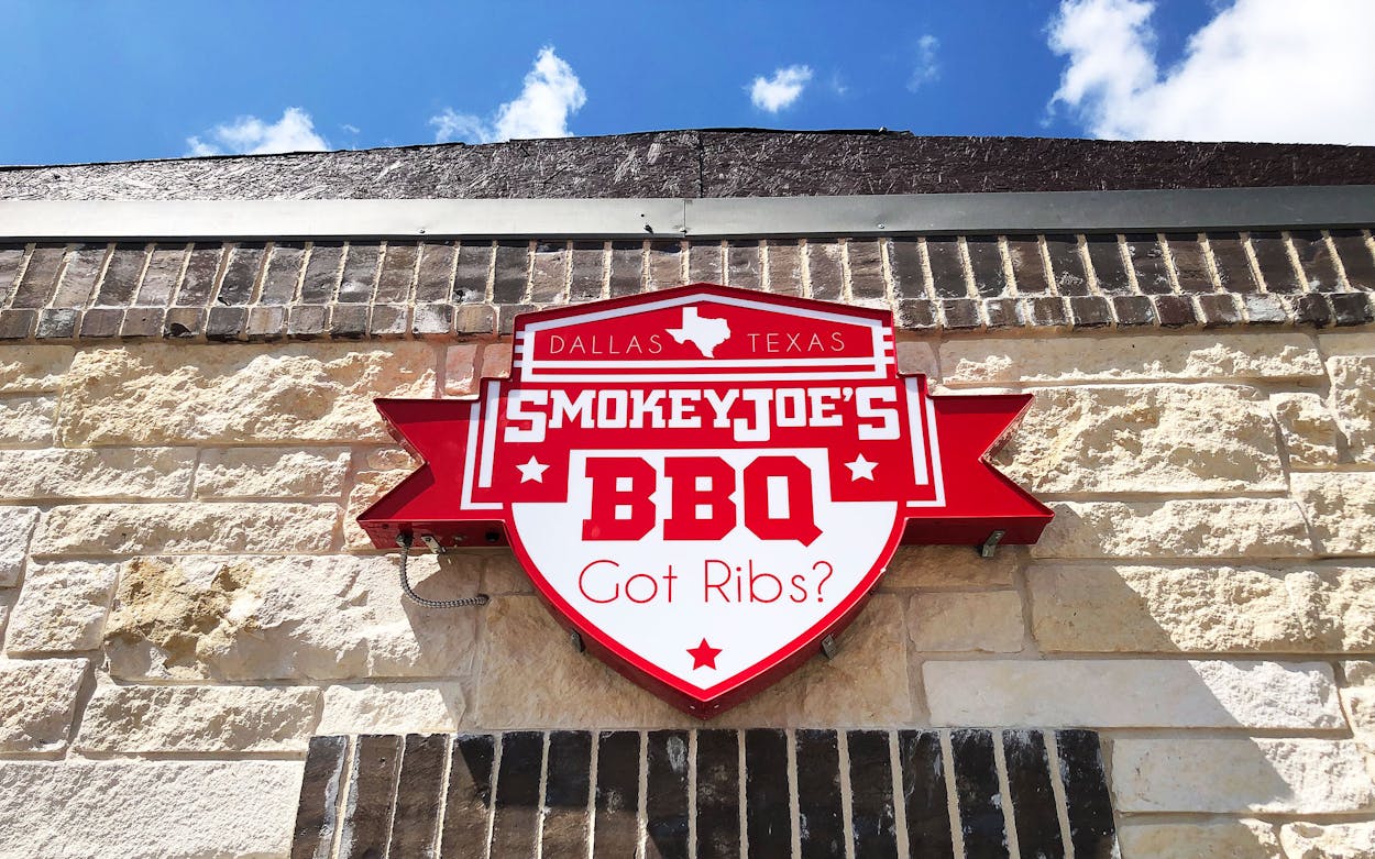 Red and white Smokey Joe’s BBQ sign on a stone building in Amarillo’s Route 66 Historic District.