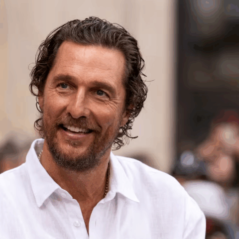 Matthew McConaughey smiling outdoors in Austin, Texas.
