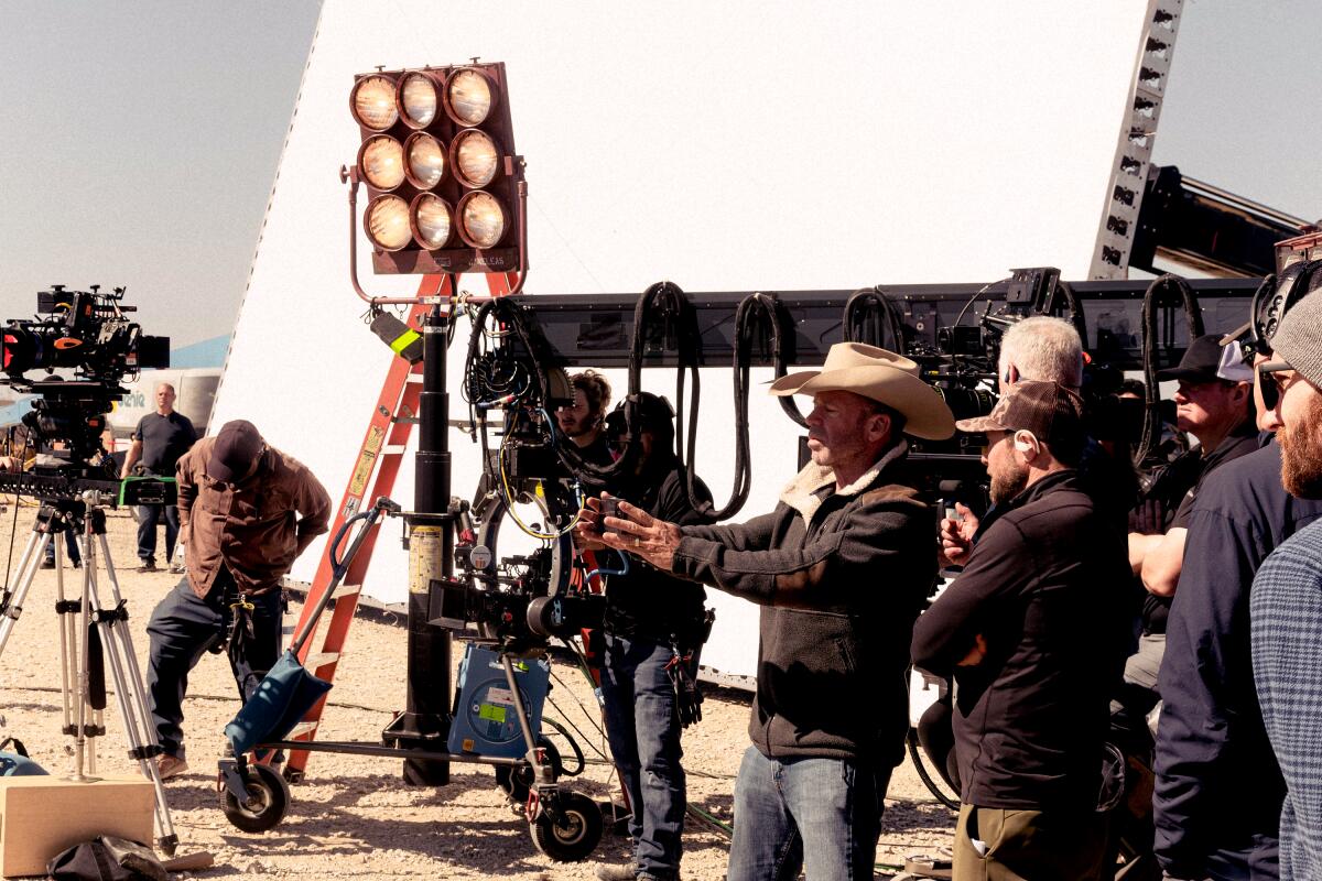 Film crew and director on a Texas movie set with cameras and lighting equipment, showing the state’s growing production infrastructure.