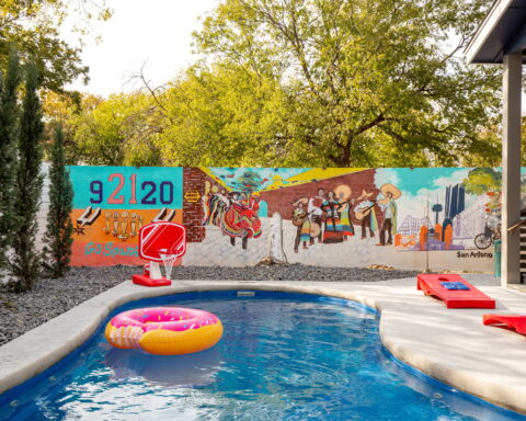 The backyard that says: “We’re not going anywhere for a while.” Hot tub bubbles, backyard games, sunset skies—pure San Antonio vibes.