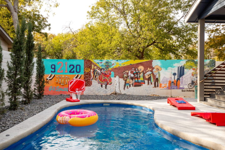 The backyard that says: “We’re not going anywhere for a while.” Hot tub bubbles, backyard games, sunset skies—pure San Antonio vibes.