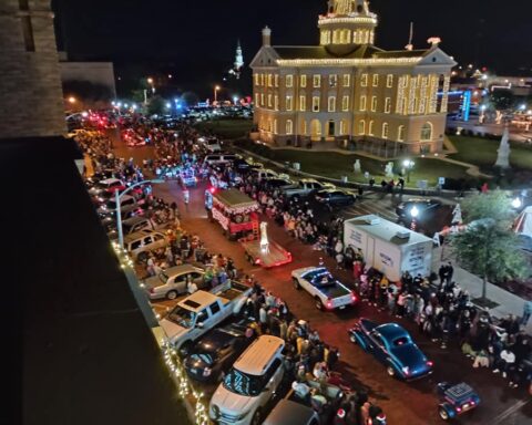 Christmas parade in Marshall Texas showcasing one of the most Christmasy towns in Texas with holiday lights and festive crowds