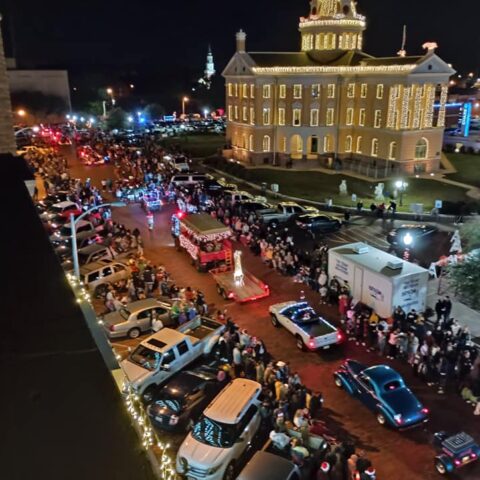 Christmas parade in Marshall Texas showcasing one of the most Christmasy towns in Texas with holiday lights and festive crowds