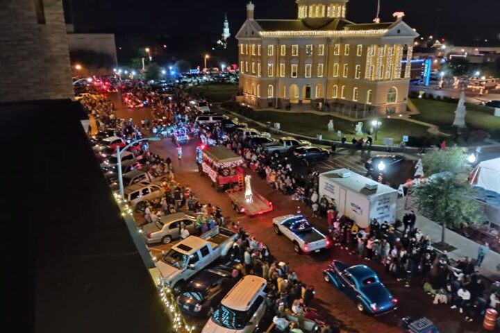 Christmas parade in Marshall Texas showcasing one of the most Christmasy towns in Texas with holiday lights and festive crowds