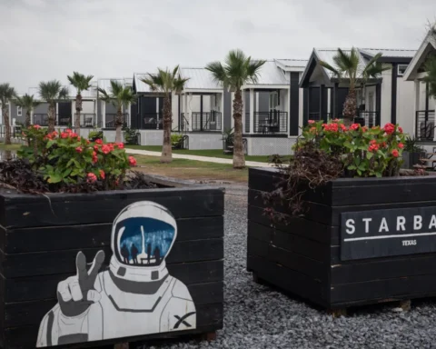 Row of modern tiny homes and astronaut-themed planters near SpaceX Starbase, showing what it’s like to visit Starbase.