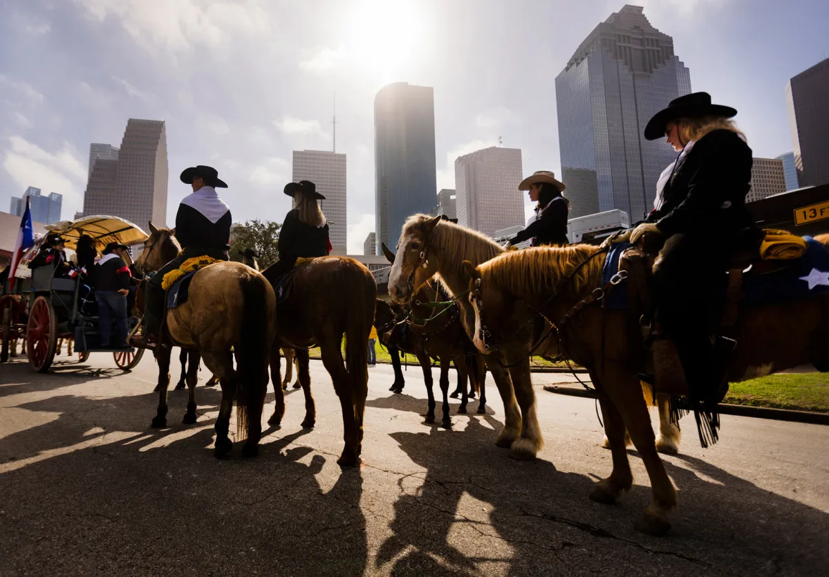 Trail riders on horseback in downtown Houston during the 2026 Houston Rodeo citywide celebration