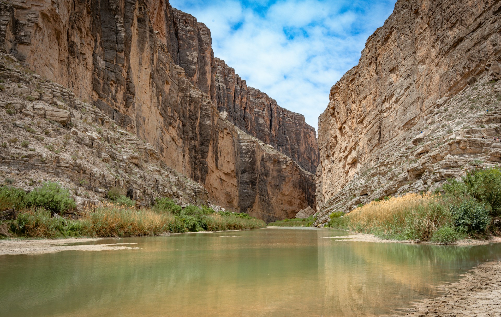 Santa Elena Canyon in Big Bend National Park, Texas, with towering limestone walls rising above the Rio Grande River. Scenic view featured in a Texas nature guide highlighting the state's most remarkable natural landscapes.