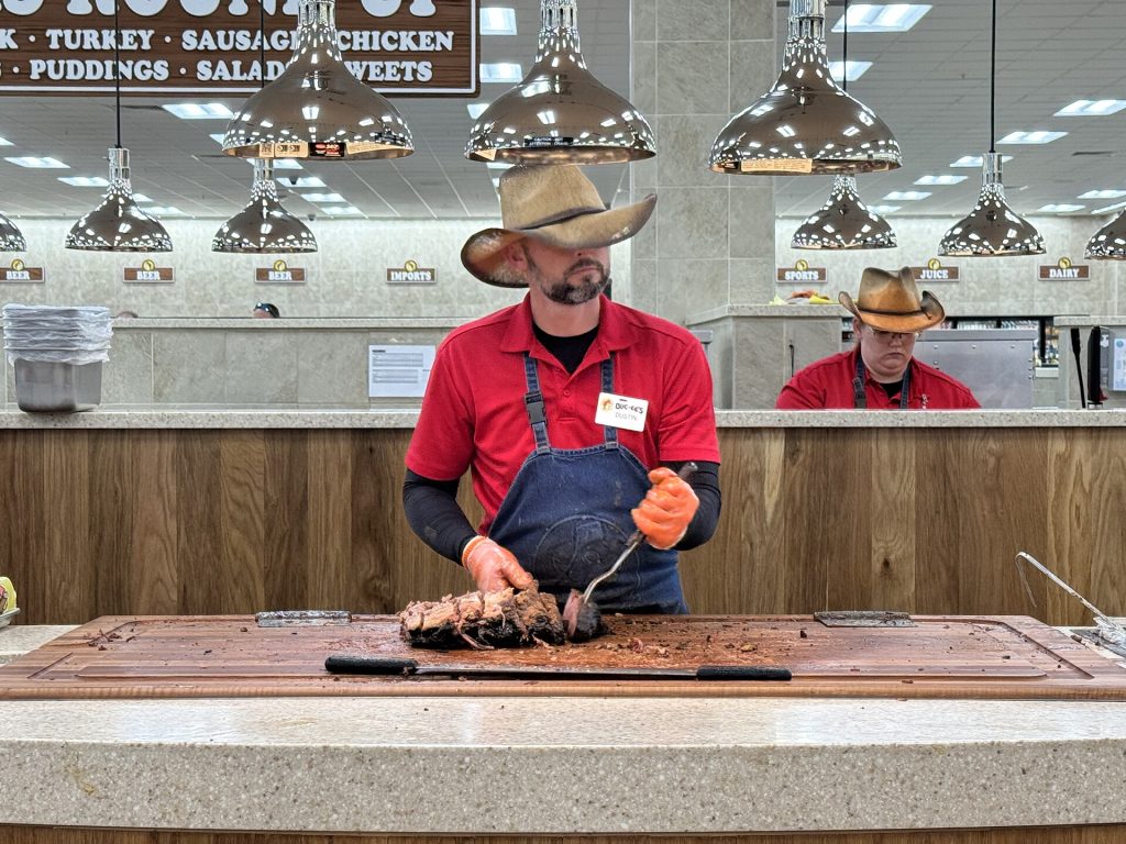 Carving brisket at the barbecue counter of a Buc-ee's travel center, shown here at the Sevierville, Tennessee, location