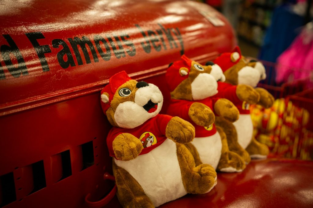 Plush beavers in red shirts, one of the many souvenirs that fill the shelves at Buc-ee's