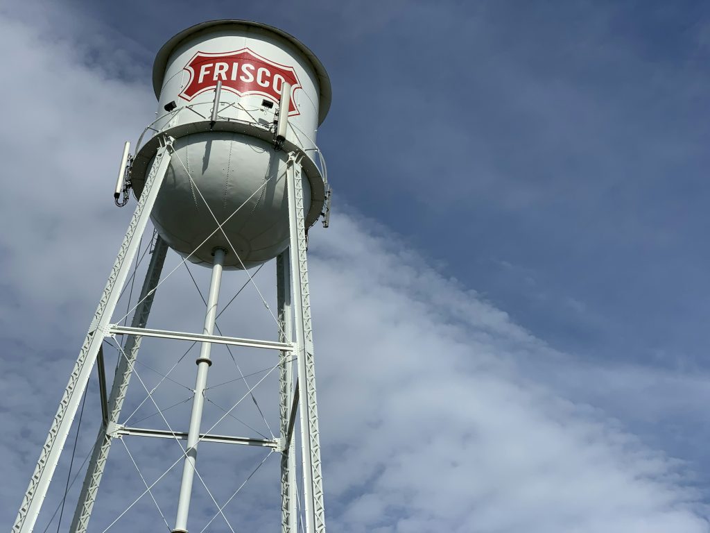 Frisco water tower against a blue sky in Frisco, Texas