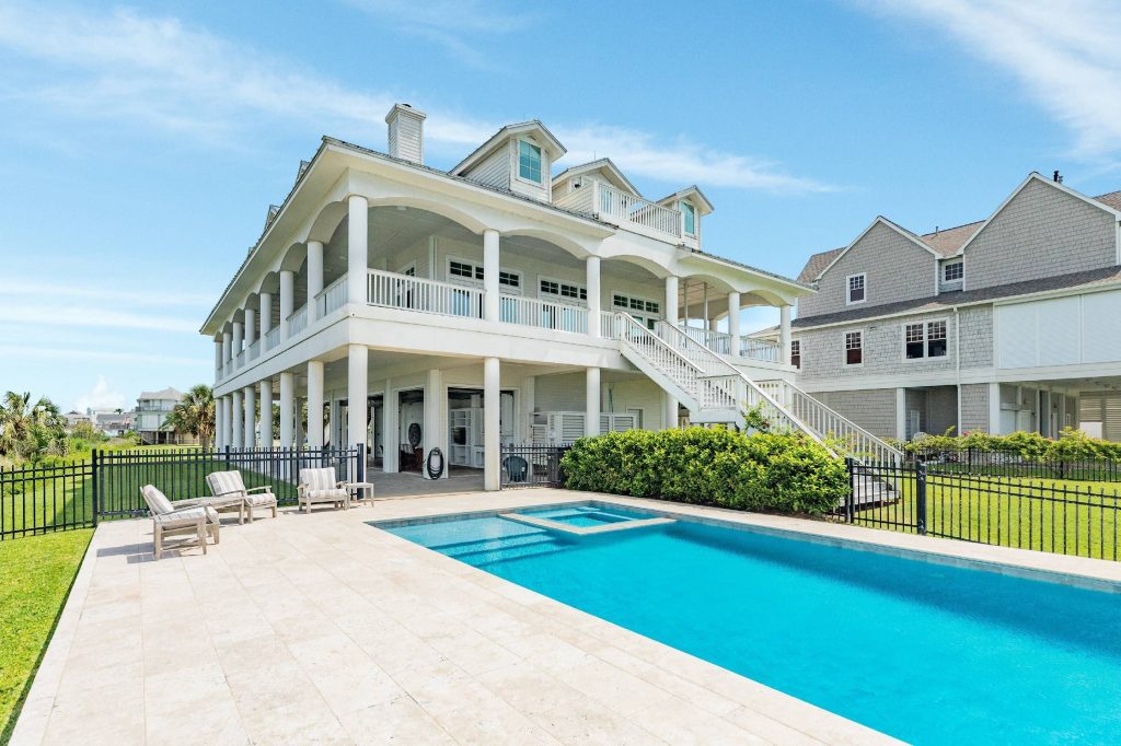 The private pool and wraparound porches at a bayfront estate on Galveston's West End