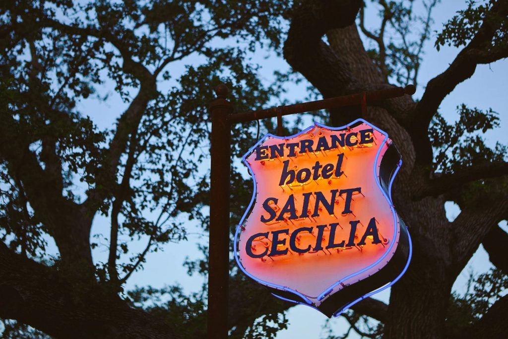 The entrance sign at Hotel Saint Cecilia, tucked under the oaks just off South Congress.