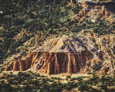 Bands of red, white, and lavender rock, often called the Spanish Skirts, line the cliffs of Palo Duro Canyon