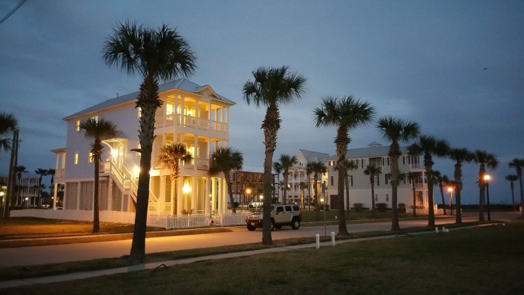 SeaGlass, a custom beach house in Galveston's Beachtown community, glowing at dusk