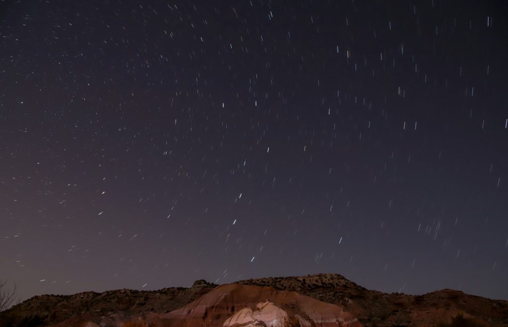 Stars fill the night sky above the rim of Palo Duro Canyon