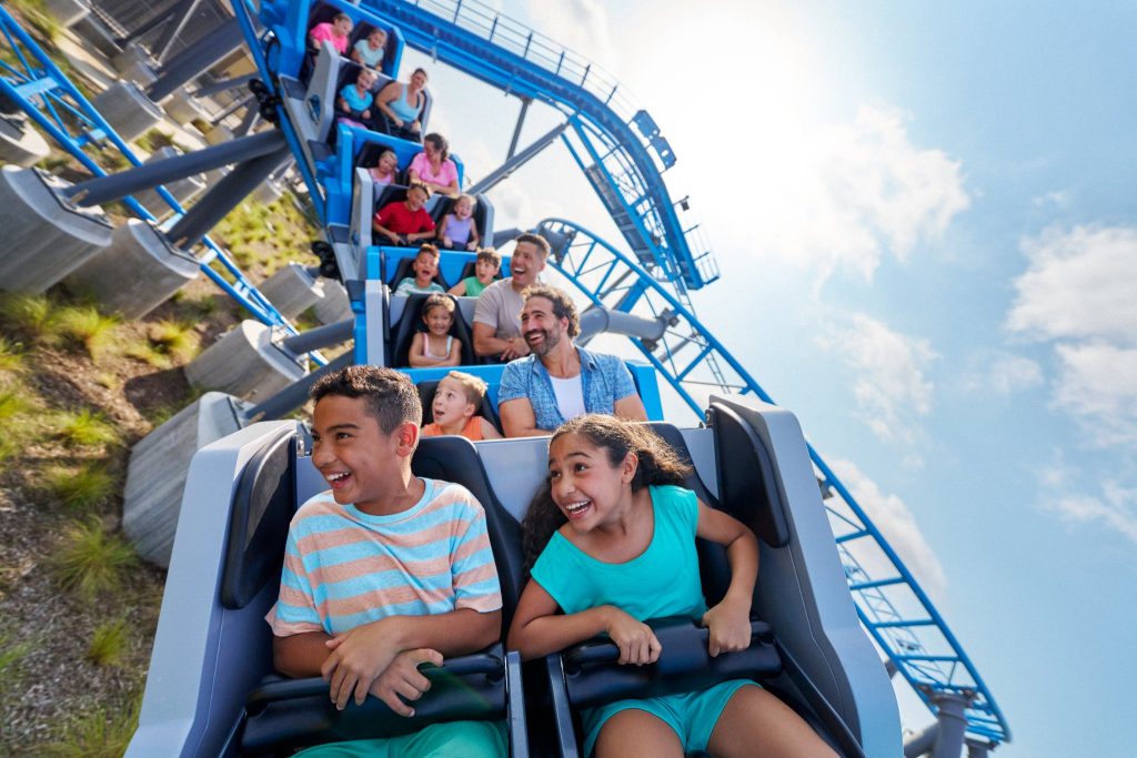 Families ride the Jurassic World Cretaceous Coaster at Universal Kids Resort